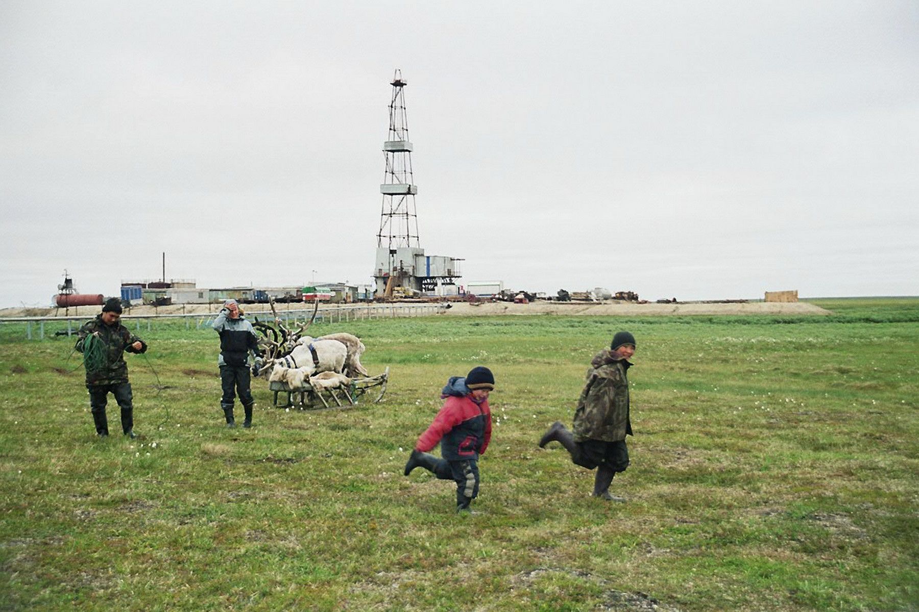 Stammler - Children from camp 2 playing on a pasture close to an oil rig on the Toravei deposit Nenets AO Barents Region Russia