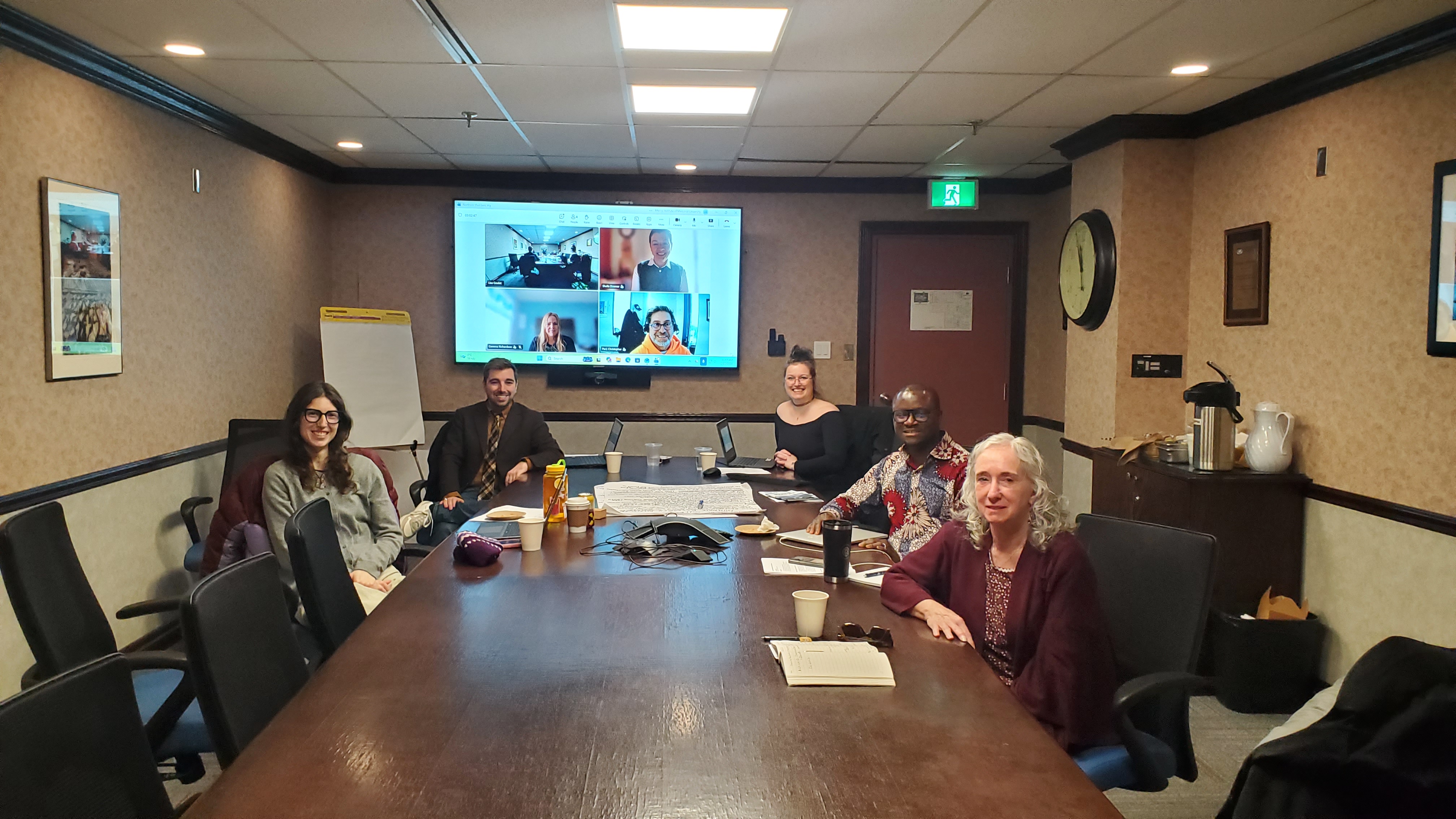 The group is sitting around the table.