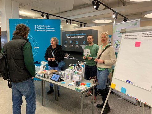 Distribution of brochures at the biodiversity education booth. From left: Tiina Pyrstöjärvi, Oskari Ylikoski and Elina Oksanen.